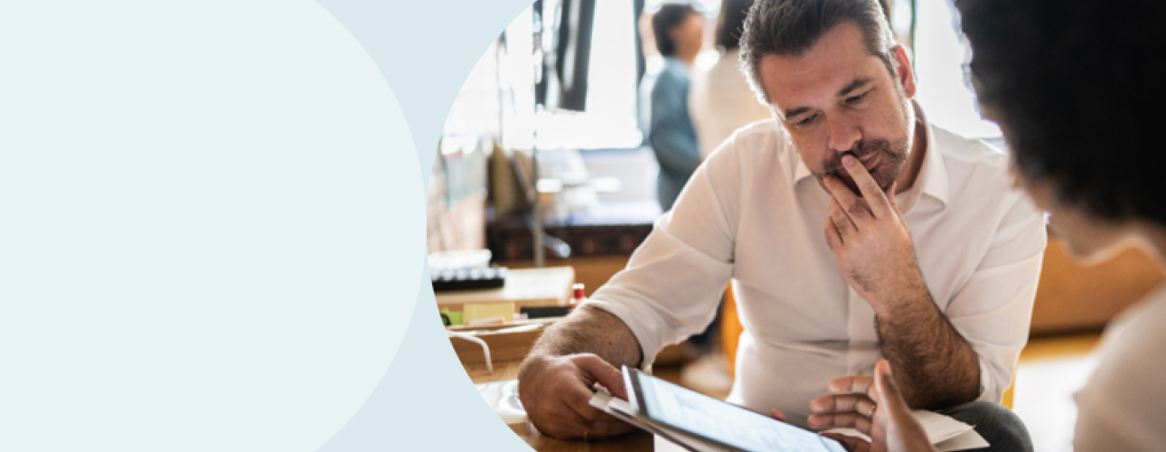 A decorative image of a man and a woman looking at an iPad screen.